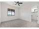 Bedroom featuring plush carpets, a large window and an open doorway to a walk-in closet at 11564 E Windsor Way, Florence, AZ 85132