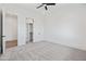 Bedroom featuring plush carpets, an open doorway to a walk-in closet and a ceiling fan at 11564 E Windsor Way, Florence, AZ 85132