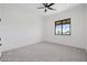 Bright bedroom with a ceiling fan, plush carpet and large windows at 11564 E Windsor Way, Florence, AZ 85132