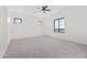 Spacious bedroom with plush carpeting, recessed lighting, and ample natural light from large windows at 11564 E Windsor Way, Florence, AZ 85132