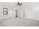 Bright bedroom with a ceiling fan, multiple closets, and access to additional living space at 11564 E Windsor Way, Florence, AZ 85132