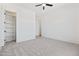Bedroom with a ceiling fan, plush carpet, and an open closet at 11564 E Windsor Way, Florence, AZ 85132