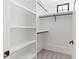 Walk-in closet featuring carpeted floor, integrated shelves and hanging rods at 11564 E Windsor Way, Florence, AZ 85132