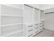 Walk-in closet with built-in shelving, drawers, and hanging rods for optimal storage at 11564 E Windsor Way, Florence, AZ 85132