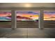 Sunset view from the covered patio overlooking a large fenced backyard and barn or storage shed at 11564 E Windsor Way, Florence, AZ 85132
