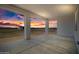 Sunset view from the covered patio overlooking a large fenced backyard with a barn or storage shed at 11564 E Windsor Way, Florence, AZ 85132