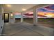 Sunset view from the covered patio with recessed lighting overlooking a large fenced backyard at 11564 E Windsor Way, Florence, AZ 85132