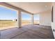 Covered patio overlooking a large fenced backyard, distant barn, and beautiful mountains at 11564 E Windsor Way, Florence, AZ 85132