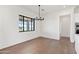 Bright dining area with a stylish chandelier and a large window providing ample natural light at 11564 E Windsor Way, Florence, AZ 85132