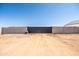 Gated driveway entrance featuring a sturdy block wall with a modern black gate, offering privacy and security at 11564 E Windsor Way, Florence, AZ 85132