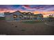 Gorgeous new construction farmhouse with a black roof during sunset at 11564 E Windsor Way, Florence, AZ 85132