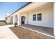 A long covered porch of this home showcases modern design at 11564 E Windsor Way, Florence, AZ 85132