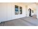 Exterior of home with long covered porch, modern lighting, and gravel landscaping at 11564 E Windsor Way, Florence, AZ 85132