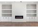 Living room built-ins and fireplace with white brick and shiplap detail create cozy space at 11564 E Windsor Way, Florence, AZ 85132