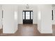 Elegant foyer features wood-look floors and a dark, glass-paneled front door at 11564 E Windsor Way, Florence, AZ 85132