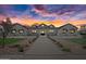 Beautiful white modern farmhouse exterior with black roof at sunset at 11564 E Windsor Way, Florence, AZ 85132