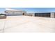A long driveway leads to a two-car garage with an automatic gate on a sunny day at 11564 E Windsor Way, Florence, AZ 85132