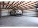 Interior of steel storage building showcasing ample room for RV parking or equipment storage, equipped with lighting at 11564 E Windsor Way, Florence, AZ 85132
