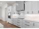 Modern kitchen featuring white cabinets, stainless appliances, and marble backsplash at 11564 E Windsor Way, Florence, AZ 85132