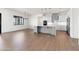 Bright, modern kitchen with a gray island, white cabinets, and stainless steel appliances at 11564 E Windsor Way, Florence, AZ 85132