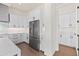 Modern kitchen features white cabinets, stainless steel refrigerator, and marble counters at 11564 E Windsor Way, Florence, AZ 85132