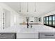 Bright modern kitchen featuring a large island with a farmhouse sink and stainless steel appliances at 11564 E Windsor Way, Florence, AZ 85132