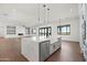 Bright modern kitchen featuring a large island with a farmhouse sink and stainless steel appliances at 11564 E Windsor Way, Florence, AZ 85132
