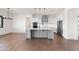 Bright kitchen features a large island, stainless appliances, white cabinets, and wood flooring at 11564 E Windsor Way, Florence, AZ 85132