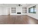 Large living room featuring a modern fireplace, built-in shelving, and a ceiling fan at 11564 E Windsor Way, Florence, AZ 85132