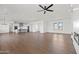 Large living area showcasing kitchen and fireplace with abundant natural light and open floor plan at 11564 E Windsor Way, Florence, AZ 85132