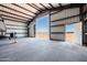 Interior view of a large metal building featuring an RV, roll up door and service door at 11564 E Windsor Way, Florence, AZ 85132