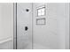 A marble tiled shower with black fixtures, a shower seat, and a soap niche at 11564 E Windsor Way, Florence, AZ 85132