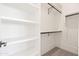 Bright walk-in closet with custom white shelves and multiple rods for optimal organization at 11564 E Windsor Way, Florence, AZ 85132