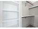 Bright walk-in closet with custom white shelves and multiple rods for optimal organization at 11564 E Windsor Way, Florence, AZ 85132
