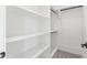 Bright walk-in closet with custom white shelves and multiple rods for optimal organization at 11564 E Windsor Way, Florence, AZ 85132