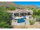Aerial view of a home with a private pool, covered patio, and desert surroundings at 11773 E Desert Trail Rd, Scottsdale, AZ 85259