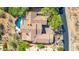 Aerial view of a luxury home featuring a tile roof, pool, and mature desert landscaping at 11773 E Desert Trail Rd, Scottsdale, AZ 85259