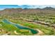 Expansive aerial view of lush golf course and luxury homes, with the mountains in the background at 11773 E Desert Trail Rd, Scottsdale, AZ 85259