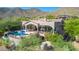 Aerial view showcasing a home with a backyard pool, covered patio, and desert landscape at 11773 E Desert Trail Rd, Scottsdale, AZ 85259