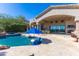 Beautiful home exterior featuring a rock-lined pool, patio, and manicured desert landscaping at 11773 E Desert Trail Rd, Scottsdale, AZ 85259