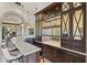 Stylish wet bar features marble countertops, mirrored backsplash, and ample storage space at 11773 E Desert Trail Rd, Scottsdale, AZ 85259