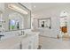 Bathroom featuring tub with chandelier, mosaic tile flooring, and double vanity at 11773 E Desert Trail Rd, Scottsdale, AZ 85259