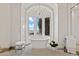 Bathroom with a soaking tub, white mosaic tile floor, chandelier, and great natural light at 11773 E Desert Trail Rd, Scottsdale, AZ 85259