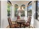 Charming dining nook bathed in sunlight, featuring a decorative chandelier and scenic outdoor views at 11773 E Desert Trail Rd, Scottsdale, AZ 85259