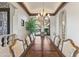 Formal dining room features a large wood table, chandelier, and an elegant design at 11773 E Desert Trail Rd, Scottsdale, AZ 85259