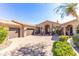Exterior view showing a three car garage, decorative brick driveway, and meticulously maintained landscaping at 11773 E Desert Trail Rd, Scottsdale, AZ 85259
