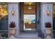 Ornate front door entry featuring stone accents, decorative lanterns, and a glimpse of the luxurious interior at 11773 E Desert Trail Rd, Scottsdale, AZ 85259