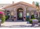 Charming home exterior with stone accents, arched entryway, and lush desert landscaping at 11773 E Desert Trail Rd, Scottsdale, AZ 85259