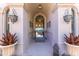 Grand arched entryway with elegant sconces, iron detailing, and view into home at 11773 E Desert Trail Rd, Scottsdale, AZ 85259