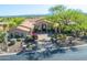Elegant home exterior showcasing mature landscaping, a circular driveway, and a stone facade at 11773 E Desert Trail Rd, Scottsdale, AZ 85259